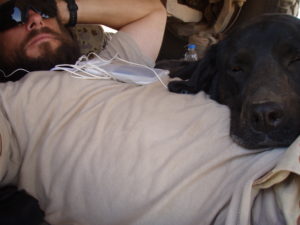 Sarbi and her handler, W.O. Simpson resting while on patrol in Afghanistan